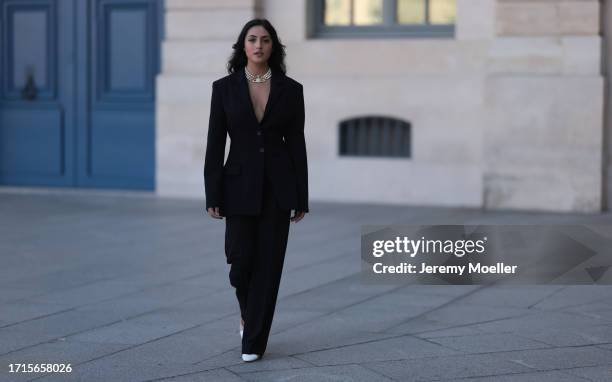 Agustina Walker Castro-Rioseco is seen wearing a three-row pearl necklace with a golden pendant covered with rhinestones from Vivienne Westwood, a...