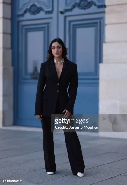 Agustina Walker Castro-Rioseco is seen wearing a three-row pearl necklace with a golden pendant covered with rhinestones from Vivienne Westwood, a...