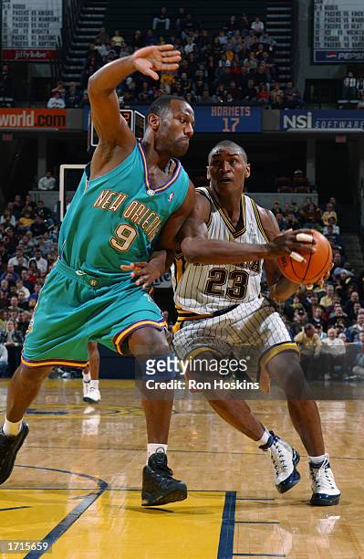 Ron Artest of the Indiana Pacers drives to the basket against George Lynch of the New Orleans Hornets during the game at Conseco Fieldhouse on...