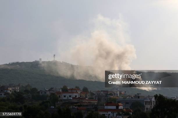 Smoke billows following Israeli artillery bombing on the outskirts of the Lebanese border village of Aita al-Shaab, from an Israeli military position...