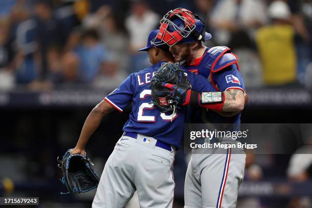 Jose Leclerc and Jonah Heim of the Texas Rangers celebrate after defeating the Tampa Bay Rays 4-0 in Game One of the Wild Card Series at Tropicana...