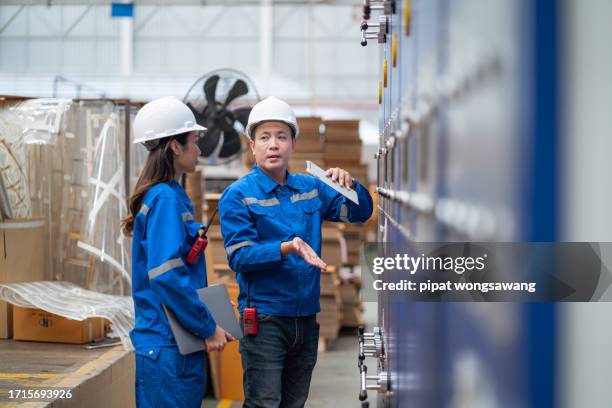 maintenance engineer inspects machinery in a cardboard parts factory. - occupational health and safety stock pictures, royalty-free photos & images