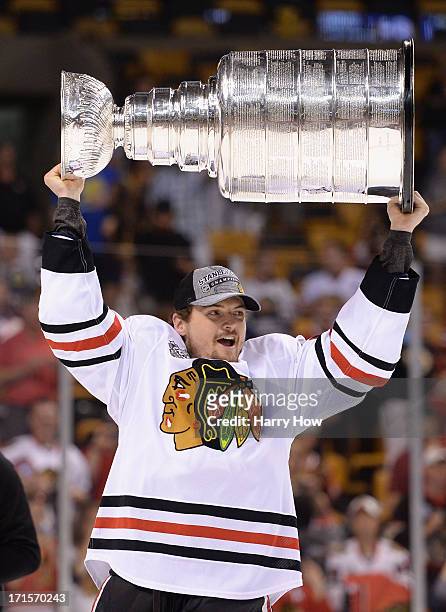 Sheldon Brookbank of the Chicago Blackhawks hoists the Stanley Cup Trophy after defeating the Boston Bruins in Game Six of the 2013 NHL Stanley Cup...