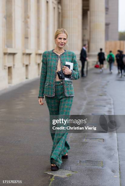 Christine Wuerfel-Stauss wears green blazer, flared pants, necklace, black bag, platform sandals outside Chanel during the Womenswear Spring/Summer...