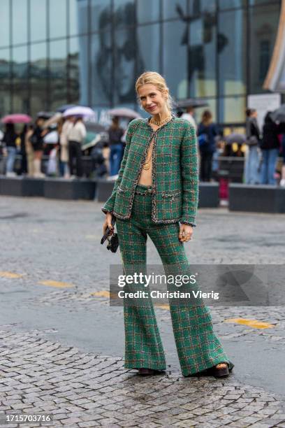 Christine Wuerfel-Stauss wears green blazer, flared pants, necklace, black bag, platform sandals outside Chanel during the Womenswear Spring/Summer...