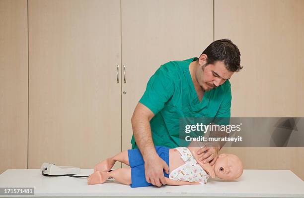 basic life support training with a cpr dummy-recovery position - basic life support training stock pictures, royalty-free photos & images