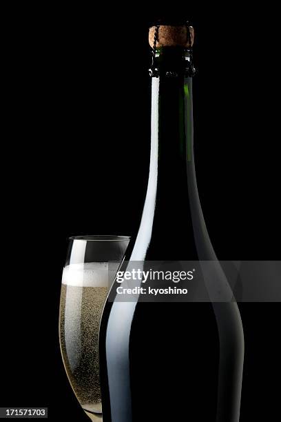 coupe de champagne et de la bouteille vide avec fond noir - champagne or photos et images de collection