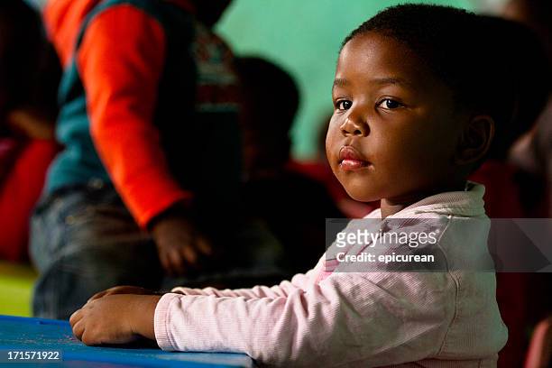 portrait of girl at class in rural south africa kindergarten - sad kid in kindergarten stock pictures, royalty-free photos & images