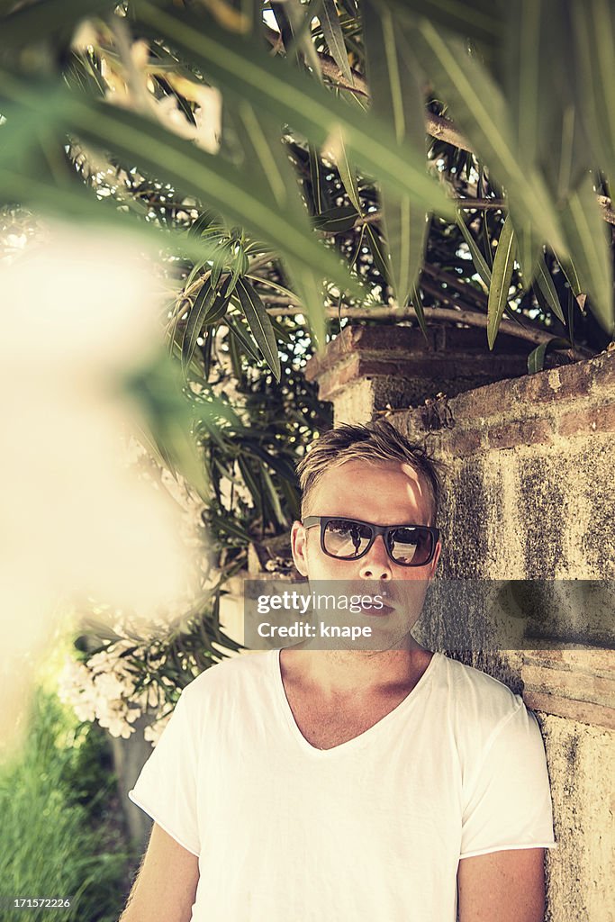 Handsome man under a oleander