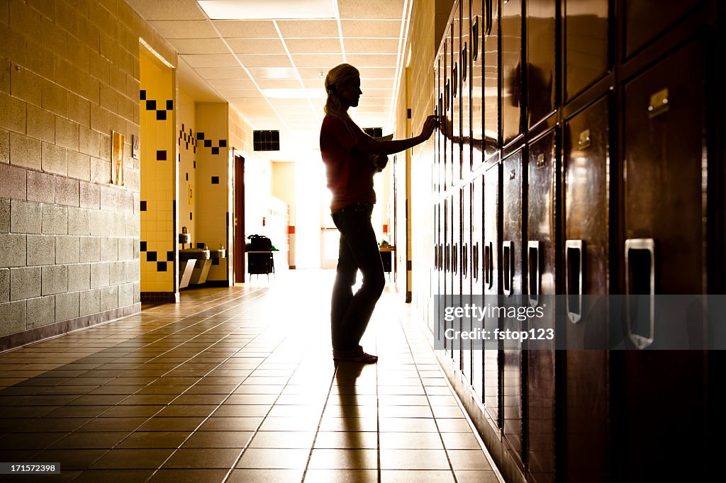 Silhouette of Student in hallway. Lockers. High school. Girl. Education.