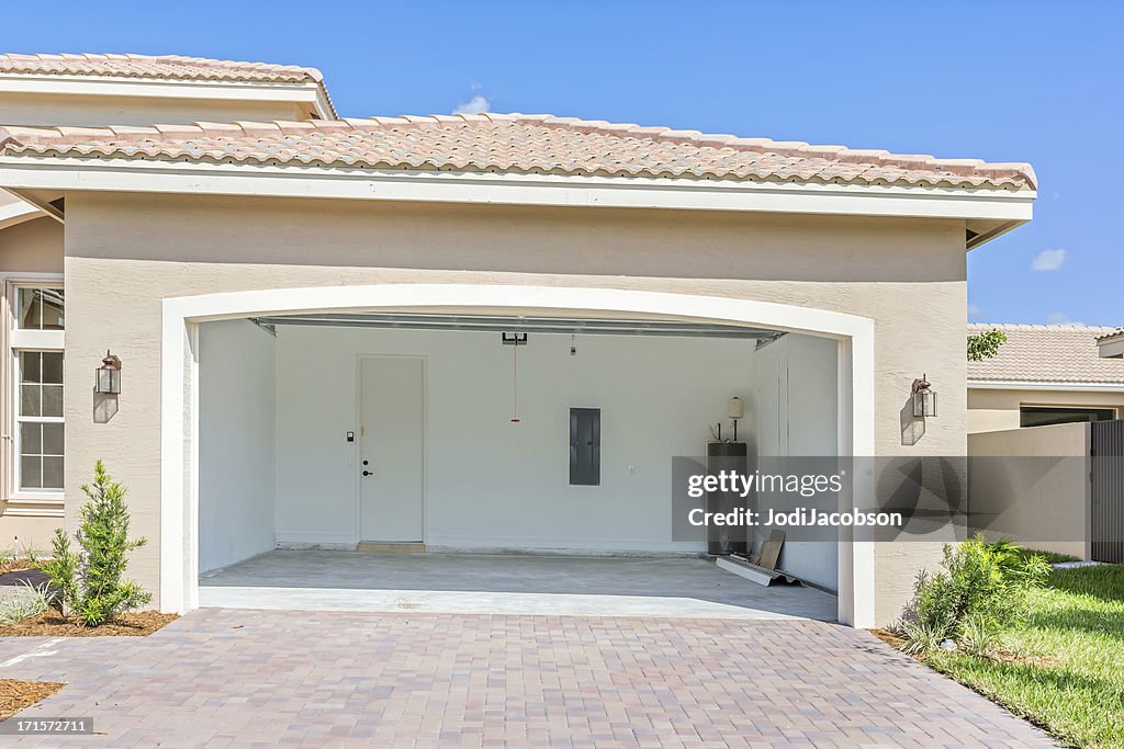 Architecture: Brand new house  being built with an empty garage