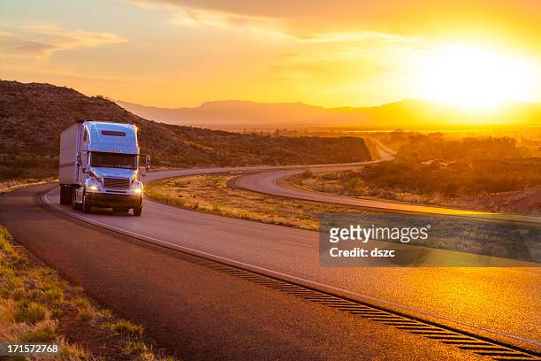 18-wheeler tractor-trailer truck on interstate highway at sunset - semi truck stock pictures, royalty-free photos & images