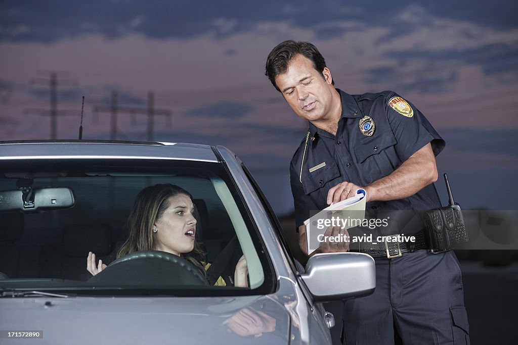 Police Officer Explaining Citation to Woman Driver