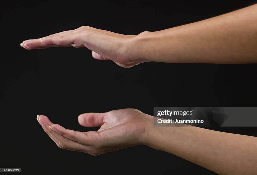 Two Woman hands holding an object