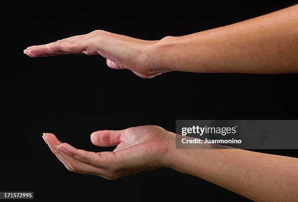 two woman hands holding an object - gripping arm stock pictures, royalty-free photos & images