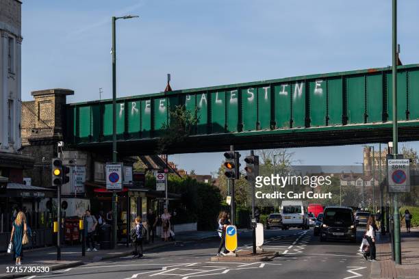 Graffiti reading 'Free Palestine' is sprayed onto a railway bridge on October 9, 2023 in the Golders Green area of London, England. The incident...