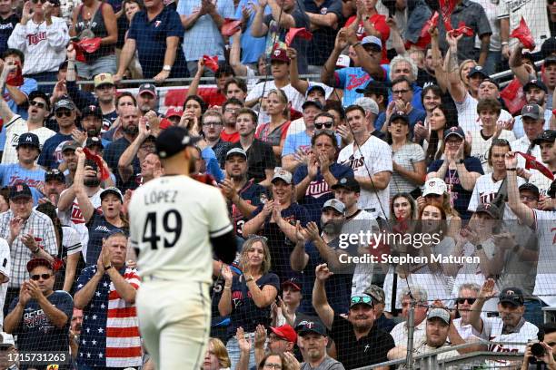 Fans cheer as Pablo Lopez of the Minnesota Twins walks back to the dugout after being relieved against the Toronto Blue Jays during the sixth inning...