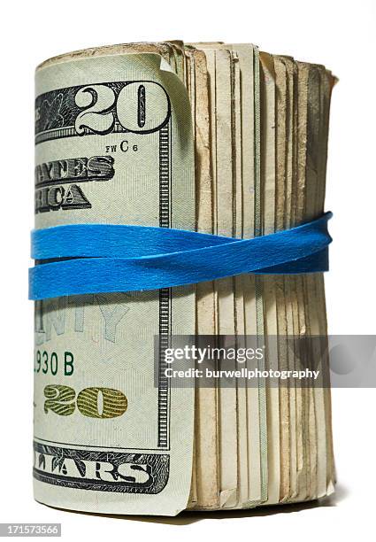 roll of money with blue rubber band,  white background - money roll stock pictures, royalty-free photos & images