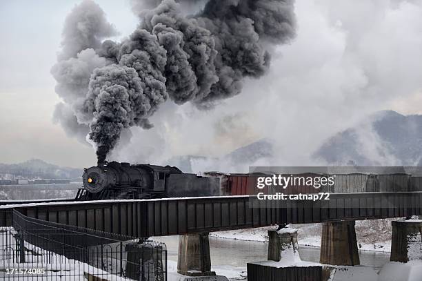 train crossing river bridge, old steam railroad locomotive in winter - 19th century steam train stock pictures, royalty-free photos & images