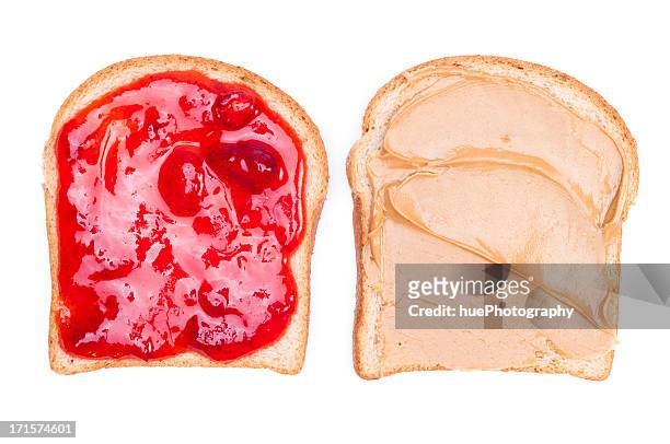 close up of a peanut butter & jelly sandwich on white bread - peanut butter and jelly sandwich stock pictures, royalty-free photos & images