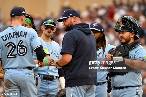 John Schneider of the Toronto Blue Jays talks with the team against the Minnesota Twins during the sixth inning in Game One of the Wild Card Series...
