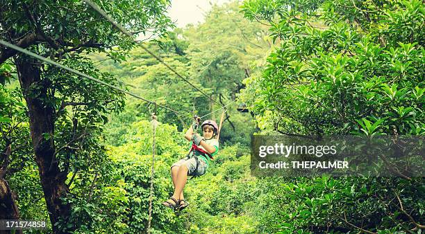 kid during a canopy tour costa rica - costa rica zipline stock pictures, royalty-free photos & images