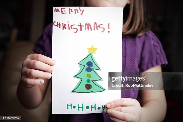 showing christmas card - kid holding crayons stockfoto's en -beelden