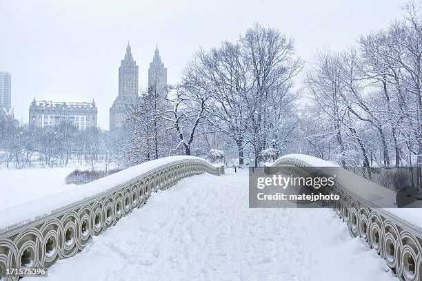 bow bridge with west side winter - central park snow stock pictures, royalty-free photos & images