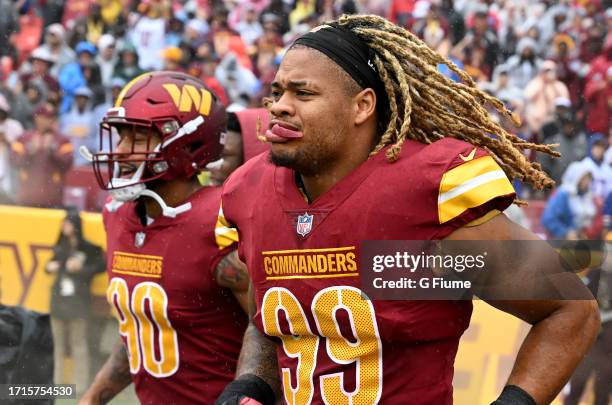 Montez Sweat and Chase Young of the Washington Commanders run onto the field before the game against the Buffalo Bills at FedExField on September 24,...