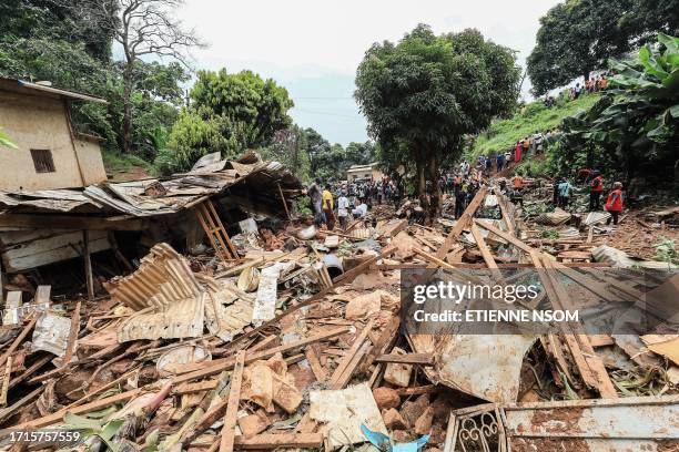 Residents look at the destruction caused by a landslide in the district of Mbankolo, northwest of Yaounde, on October 9, 2023. At least 27 people...