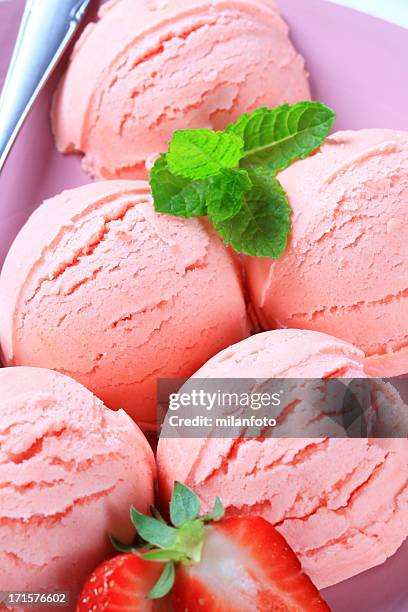 scoops of strawberry ice cream - scoop shape stockfoto's en -beelden