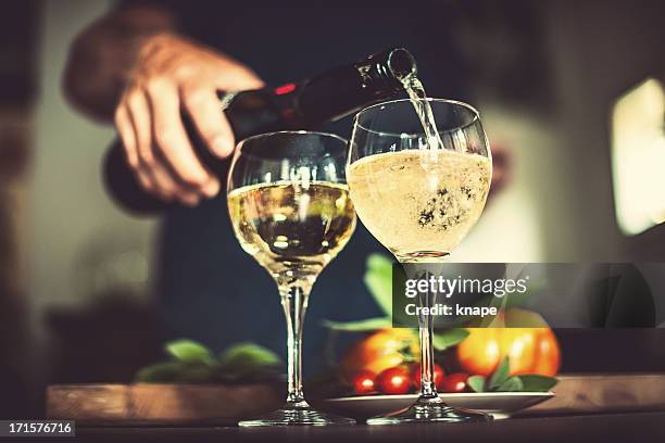 man pouring sparkling wine - prosecco stock pictures, royalty-free photos & images