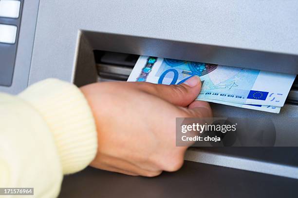 getting cash from atm..twenty euro bills - twenty euro note stock pictures, royalty-free photos & images