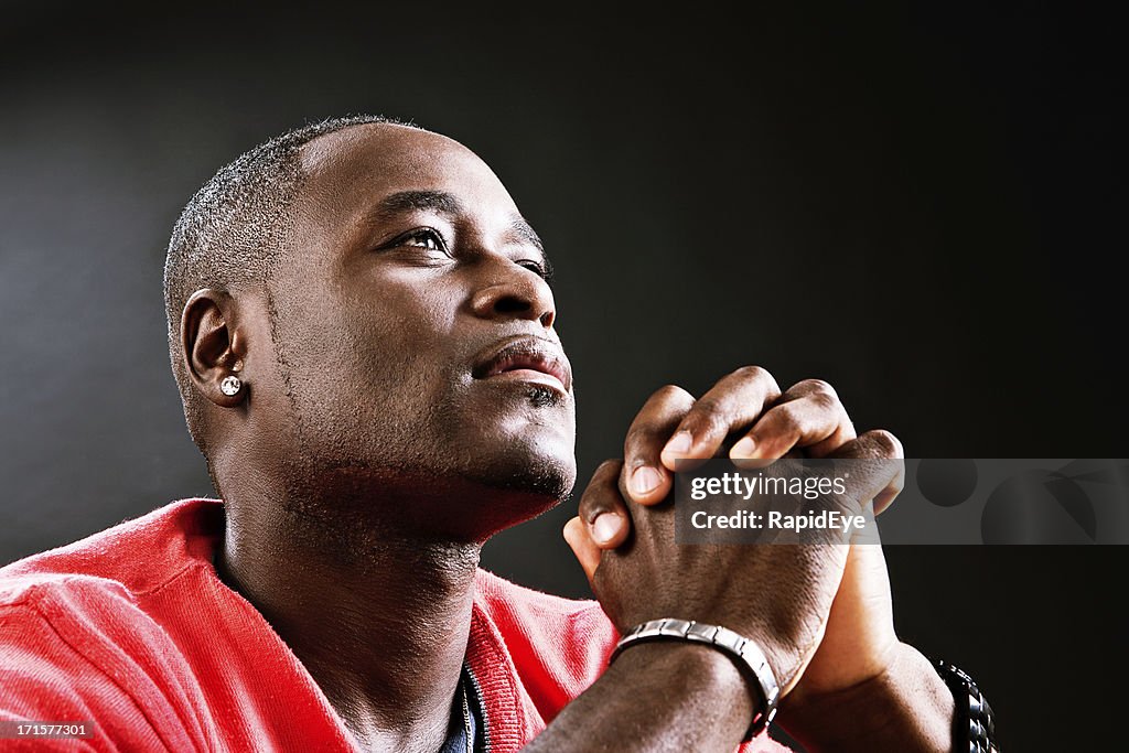 Man offers up heartful prayer, hands clasped