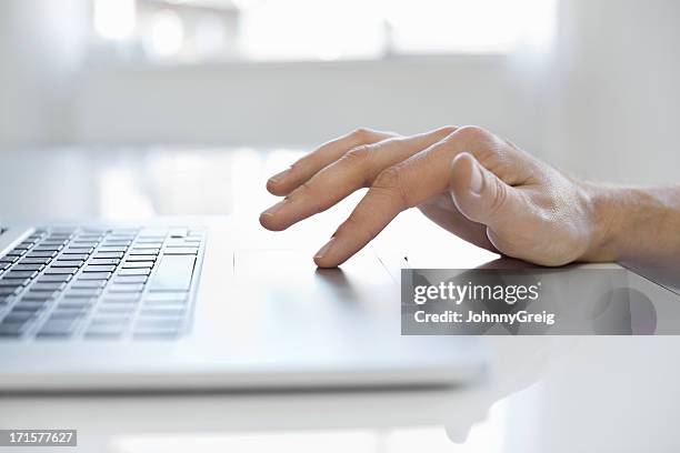 male hand using touchpad on laptop - touchpad bildbanksfoton och bilder