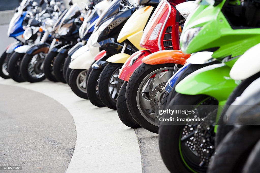 Row of motor scooters standing on the street, copy space