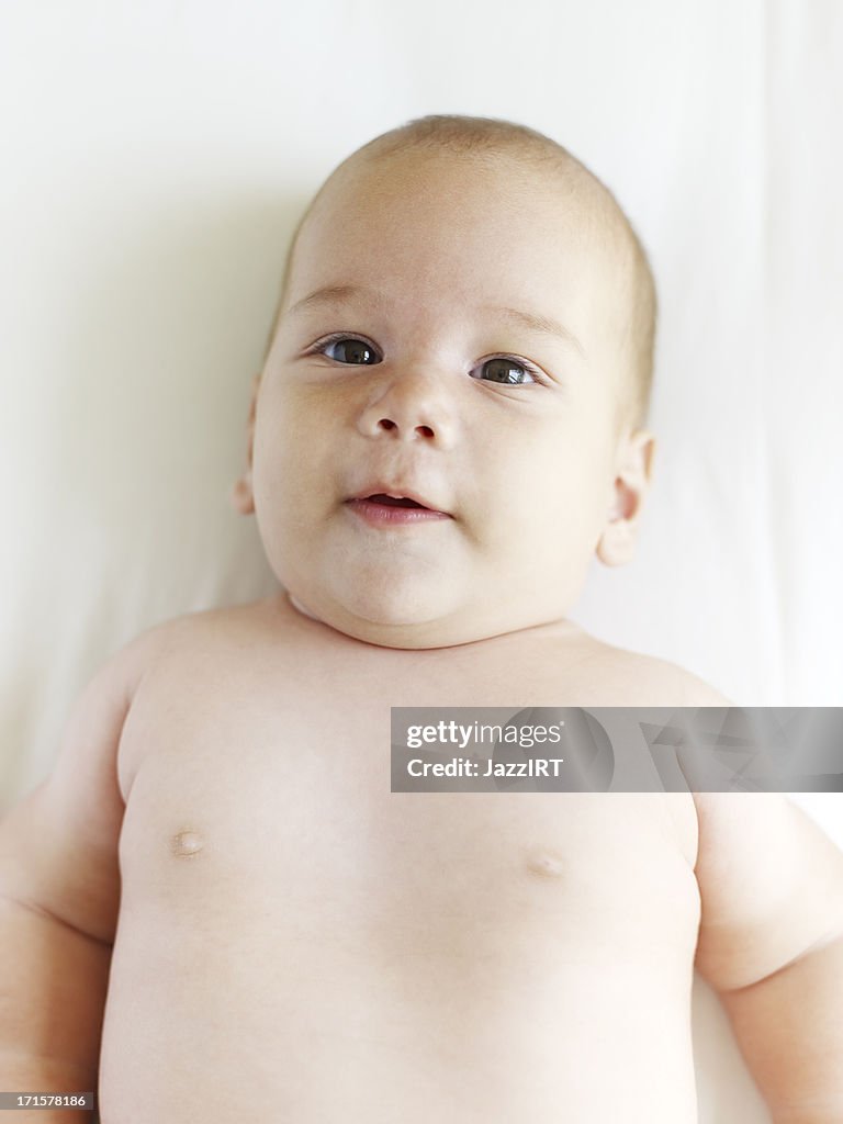 Caucasian baby boy laying on blanket