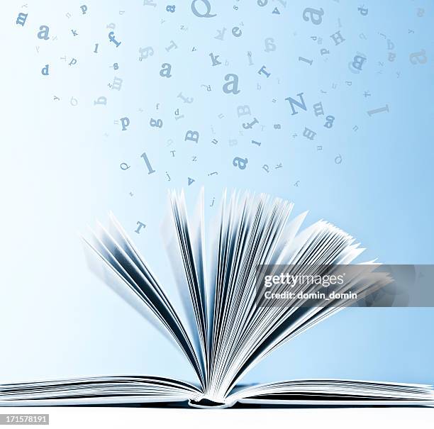 open book with flying, scattered letters isolated on blue background - science photo library stockfoto's en -beelden