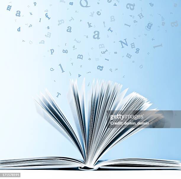 open book with flying, scattered letters isolated on blue background - dictionary page stock pictures, royalty-free photos & images