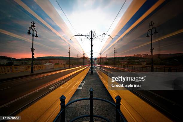 moving trams on margaret bridge, budapest - budapest train stock pictures, royalty-free photos & images