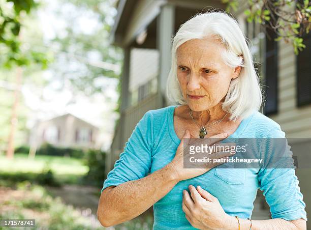 senior with chest pain - cardiovascular disease stockfoto's en -beelden