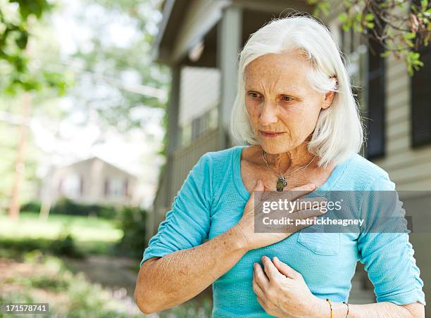 senior with chest pain - woman's chest stock pictures, royalty-free photos & images