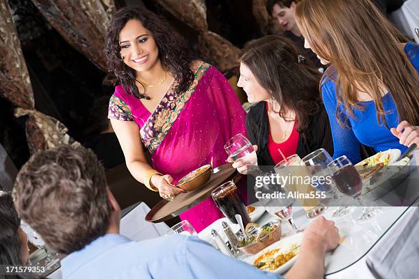 happy group of friends at an indian restaurant - indian restaurant stock pictures, royalty-free photos & images