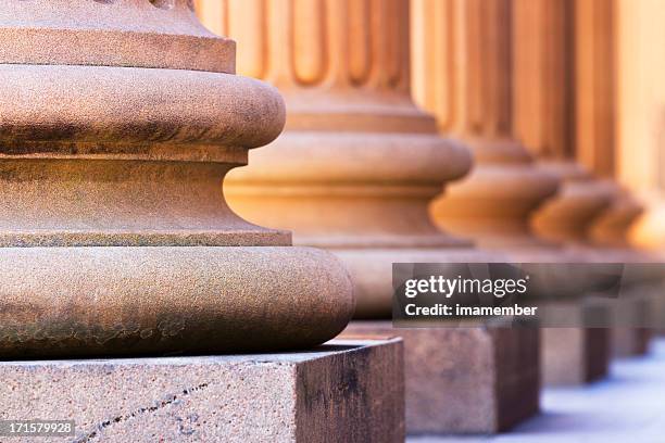 bases of marble row columns - trust concept stock pictures, royalty-free photos & images