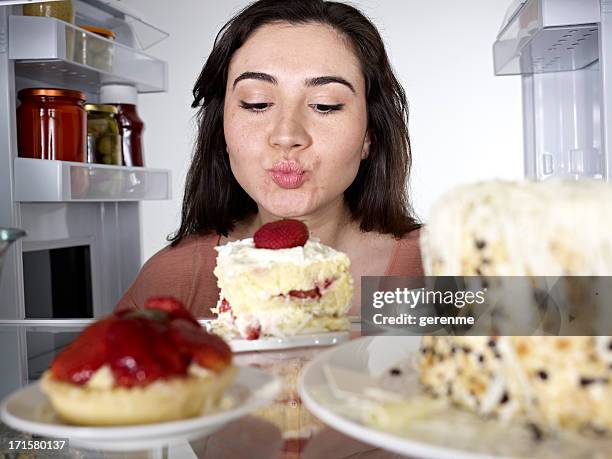 woman kissing a cake - funny fridge stock pictures, royalty-free photos & images