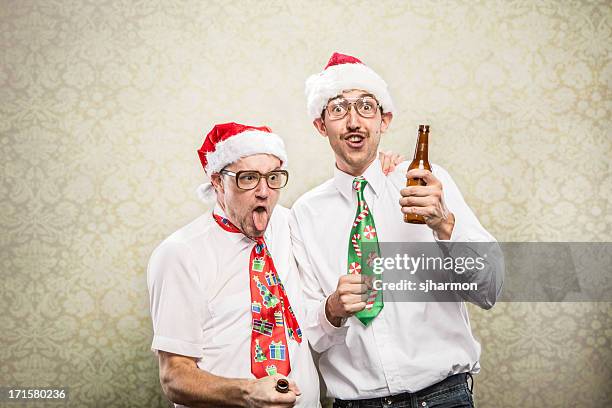 two 2 drunk goofy christmas tie wearing party nerds - ugly santa stockfoto's en -beelden