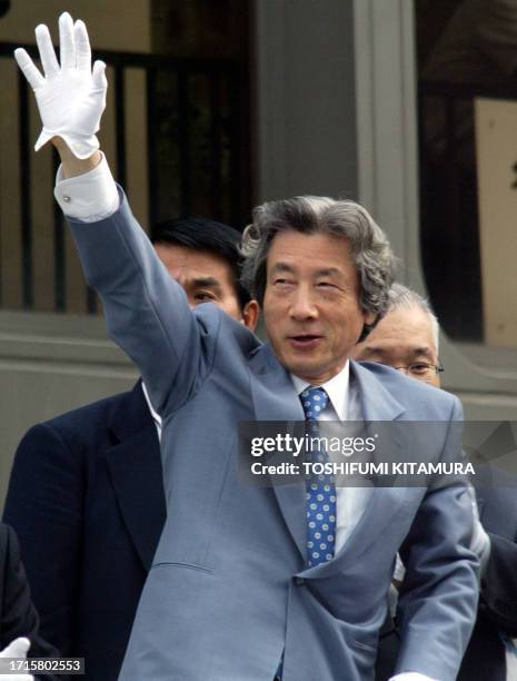 Japanese Prime Minister Junichiro Koizumi waves to supporters to start his first stumping tour since he dissolved the House of Representatives, in...