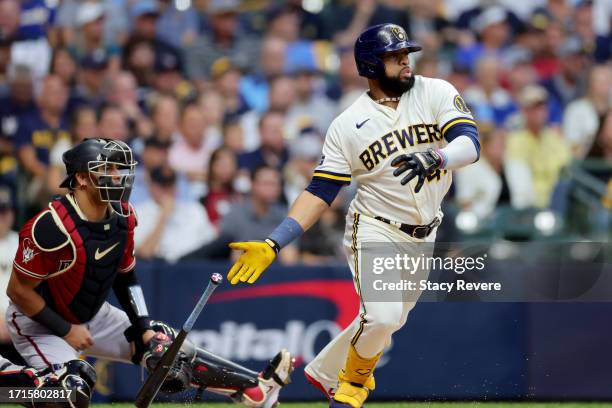 Carlos Santana of the Milwaukee Brewers hits a single in the first inning against the Arizona Diamondbacks during Game One of the Wild Card Series at...