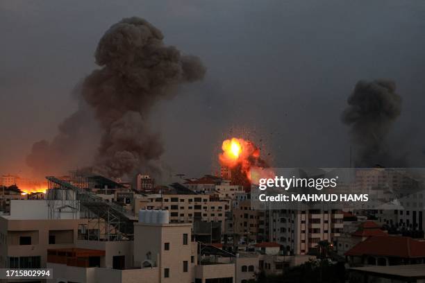 Smoke billows and debris flies in the air as the night falls on Gaza City during Israeli airstrikes on October 9, 2023. Israel relentlessly pounded...