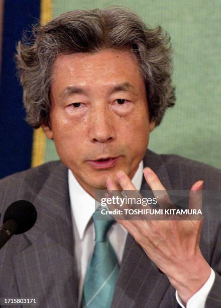 Japanese Prime Minister Junichiro Koizumi gestures while answering a question during a debate with his three challenger for the September 20...